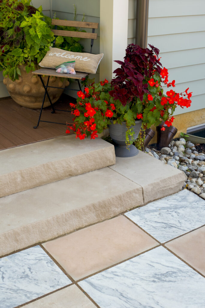 A striking checkerboard patio designed by Jaclyn Isaac using Indiana Limestone and Georgia Marble, forming the centerpiece of her outdoor living space