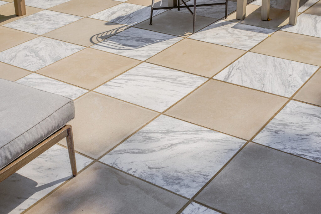 detailed view of Polycor Georgia Marble - Pearl Grey, displaying its elegant veining and cool grey tones and Polycor Indiana Limestone - Fossil Beige, featuring its earthy tones and timeless texture